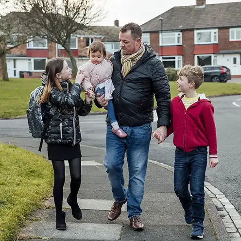 A father and his children walking together