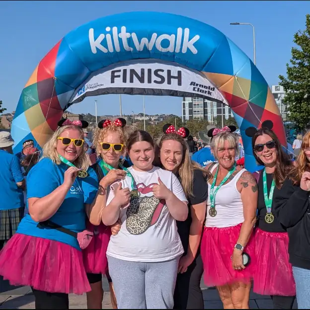A group of Kiltwalk participants celebrating together after completing their fundraising walk