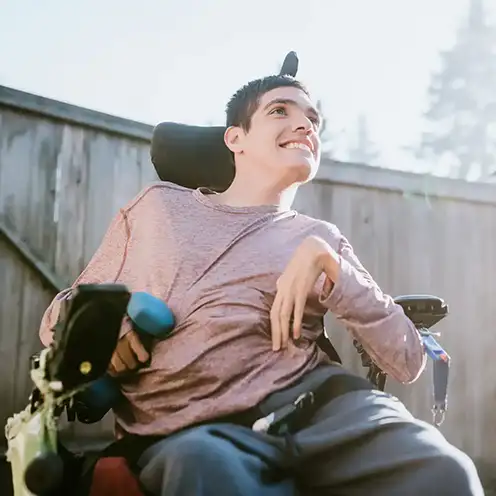 A young man smiling outdoors at Aberlour's Hopetoun Court Options service in Aberdeen