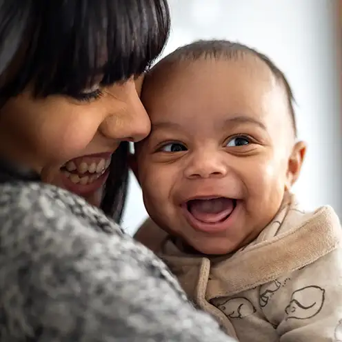 A mother laughing with her baby, supported by Aberlour's Intensive Perinatal Services