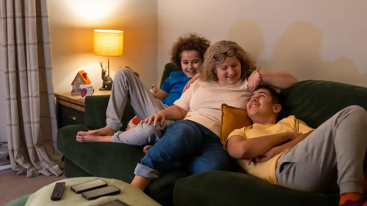 A grandmother with her grandchildren relaxing together at home