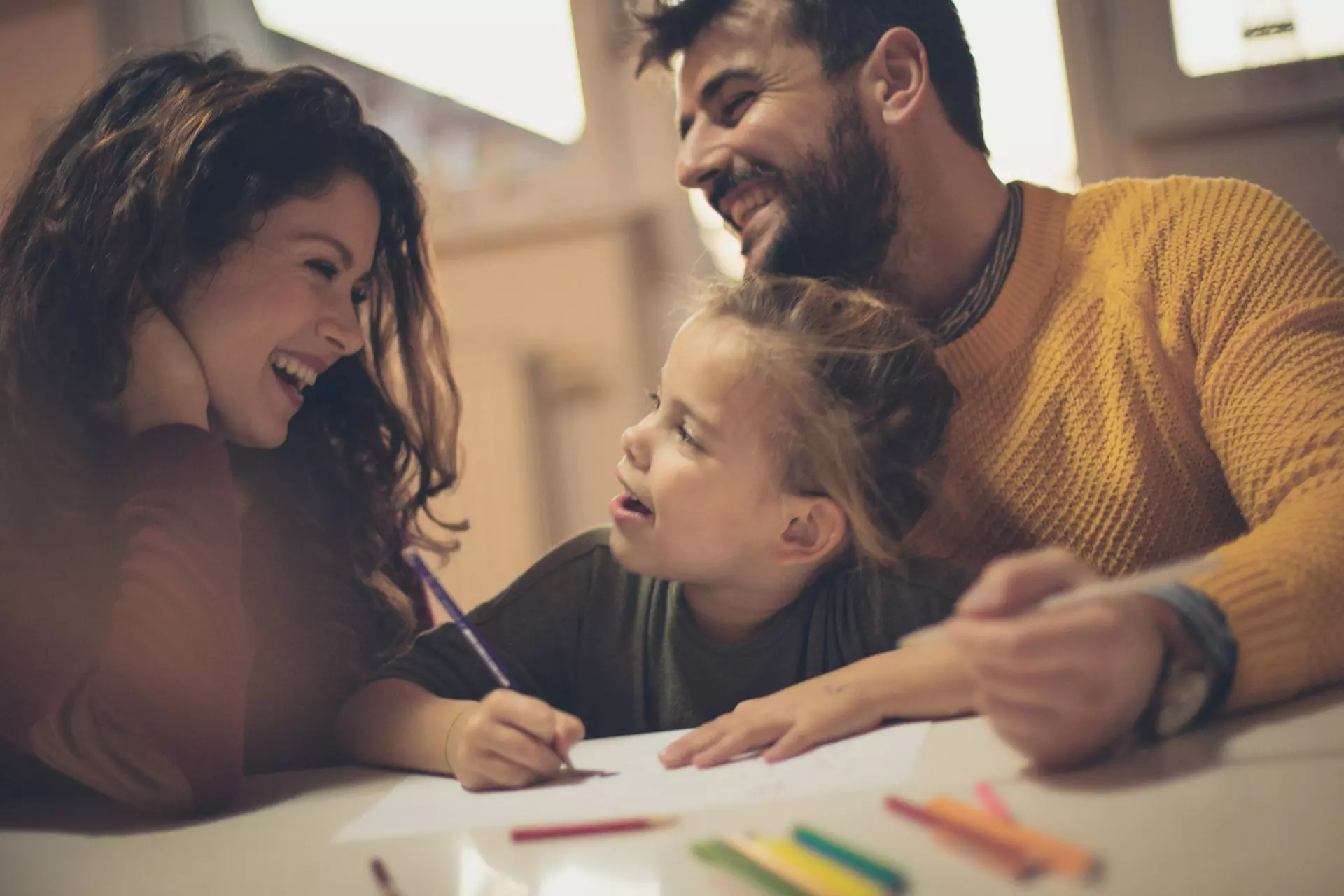 Fostering parents enjoying fun activity with foster daughter